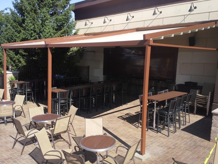 Wooden Pergolas from LEVEL by Sunair level pergola awning over small seating area under shade and in the sun